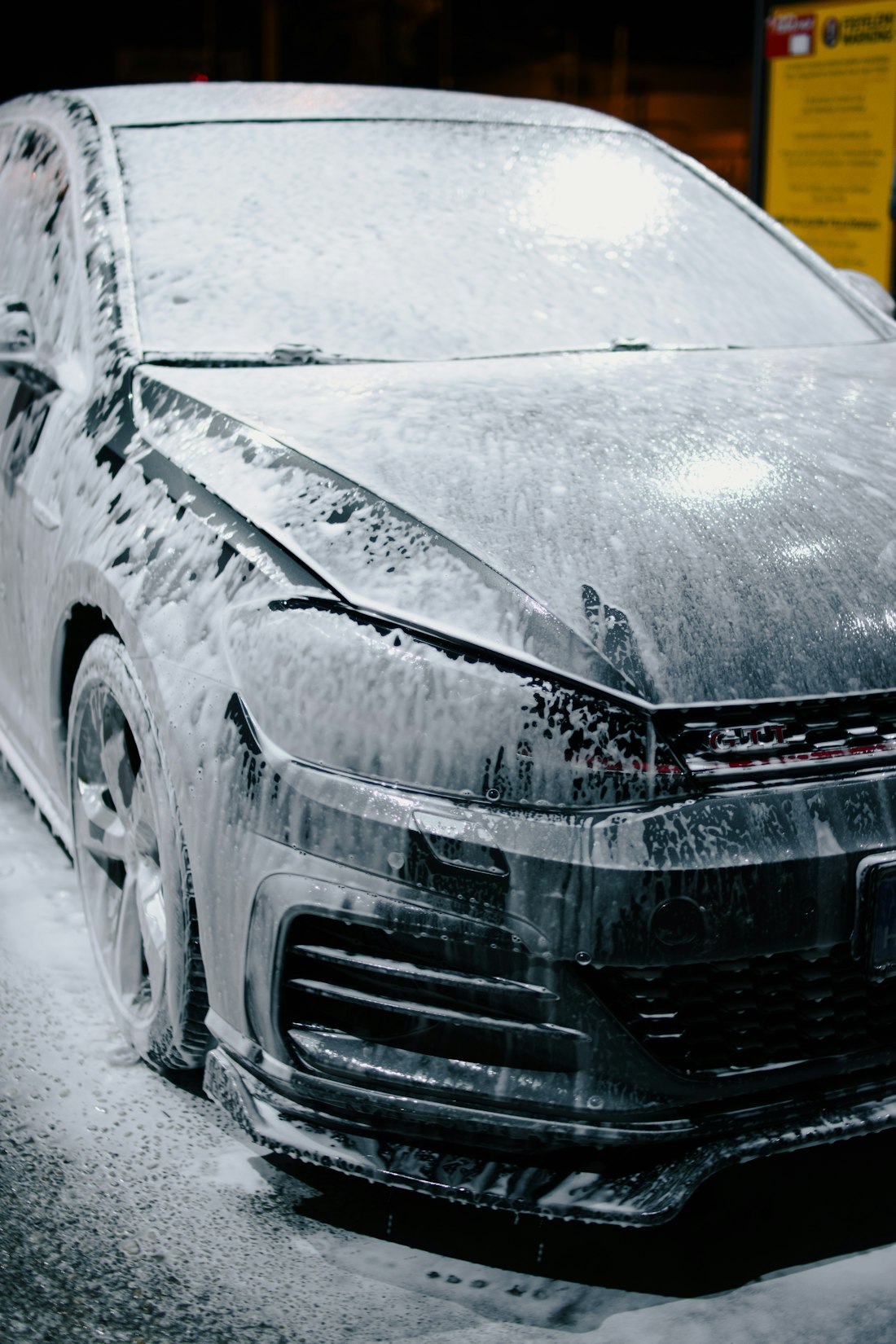 Carro coberto de espuma durante lavagem; imagem ilustrativa